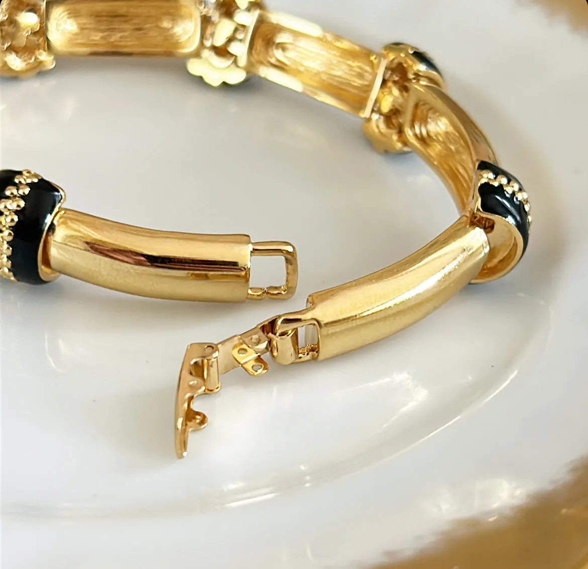 90s signed St.John designer gold link metal bracelet with black enamel accents.